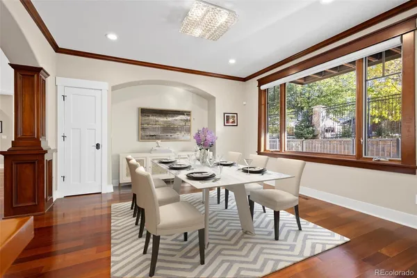 a kitchen with stainless steel appliances granite countertop a stove a sink dishwasher and a refrigerator with wooden floor