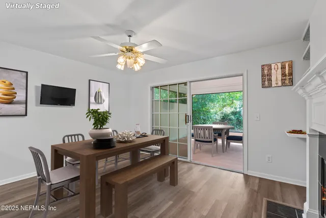 a dining room with furniture a window and wooden floor