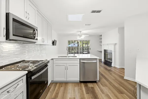 a view of storage and utility room with stairs and chandelier