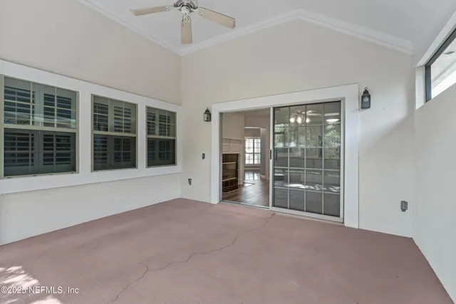 a view of empty room with floor to ceiling window and windows