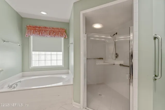a bathroom with a shower and a bath tub