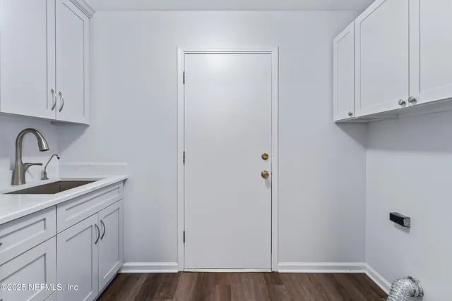 a view of a kitchen with sink and cabinets
