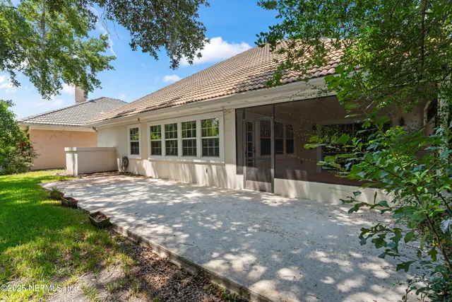 a view of a house with a yard and tree s