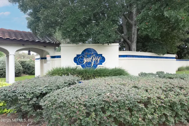 a view of a wooden house with a yard and large trees