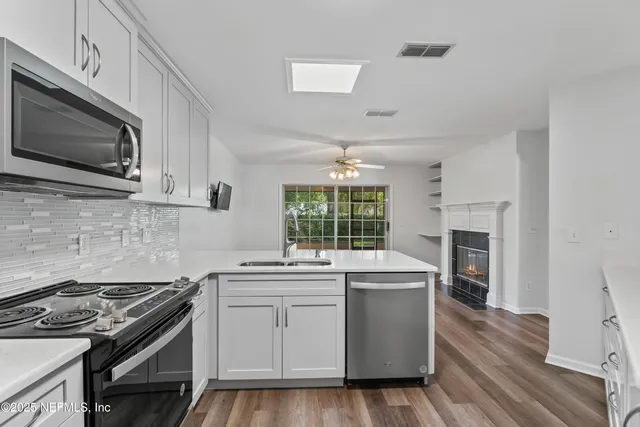 a kitchen with a stove sink and microwave