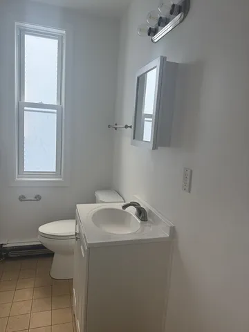 a bathroom with a sink toilet and a mirror