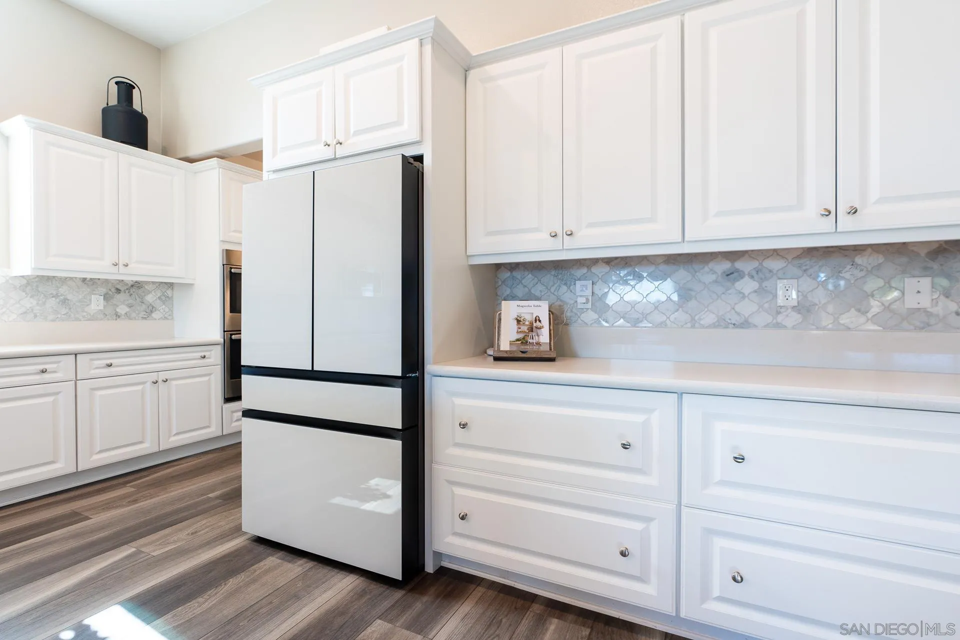 1712 Starlight Avenue Beaumont, CA 92223 - Photo 16 of 69 a kitchen with white cabinets and white appliances