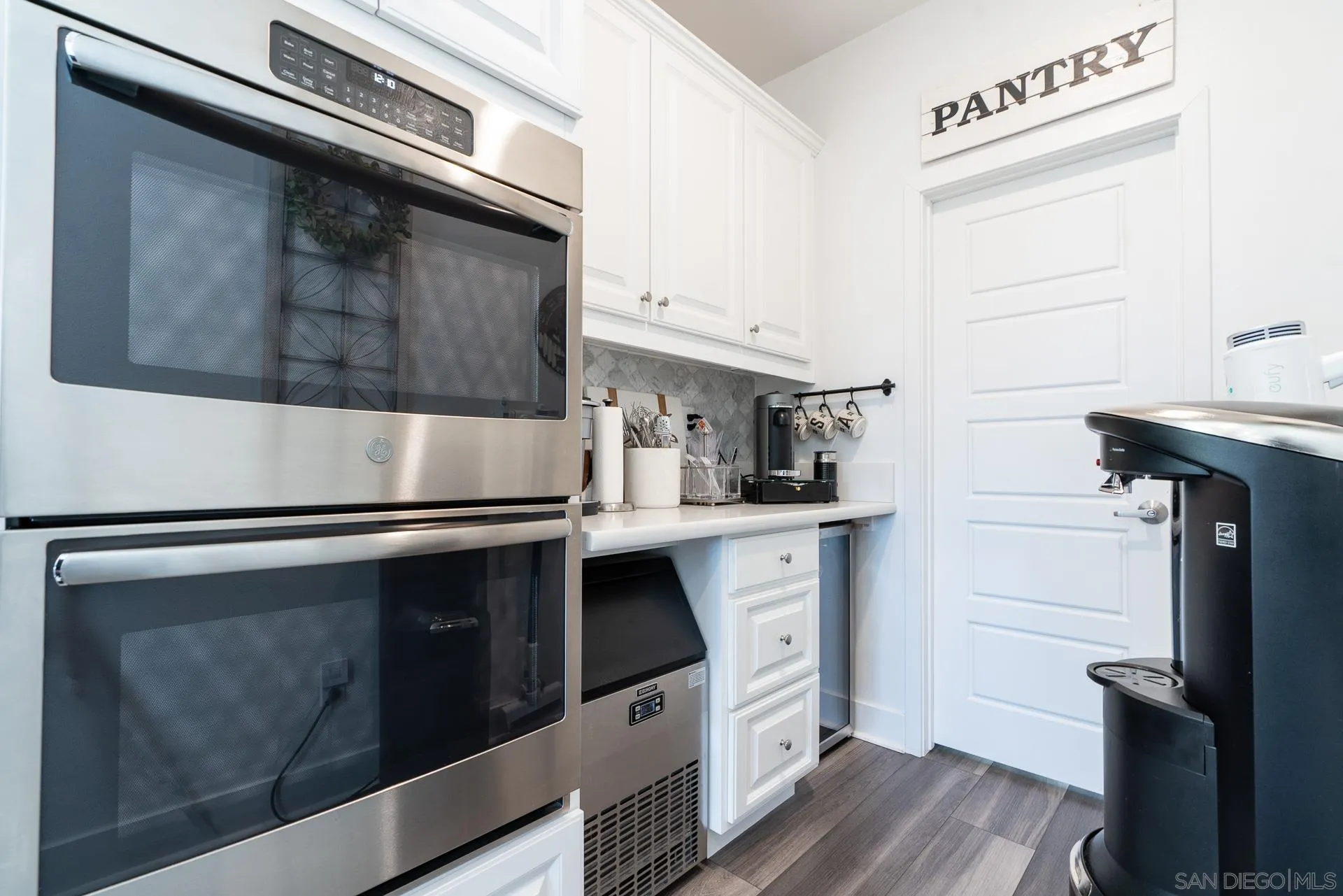1712 Starlight Avenue Beaumont, CA 92223 - Photo 17 of 69 a kitchen with stainless steel appliances a stove microwave and cabinets