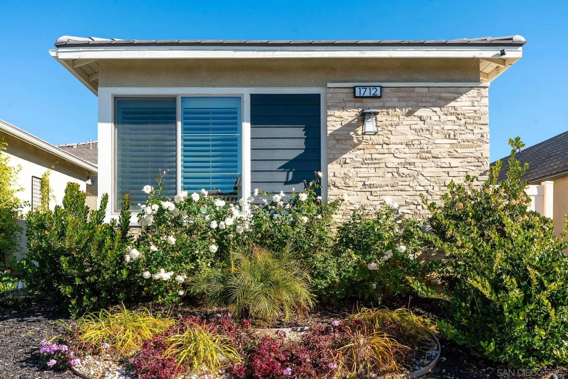 1712 Starlight Avenue Beaumont, CA 92223 - Photo 2 of 69 a view of a house with a flower garden
