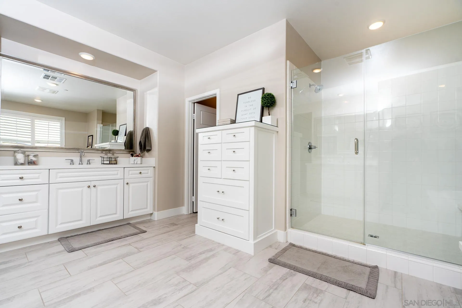 1712 Starlight Avenue Beaumont, CA 92223 - Photo 27 of 69 a bathroom with a double vanity sink a shower and a mirror
