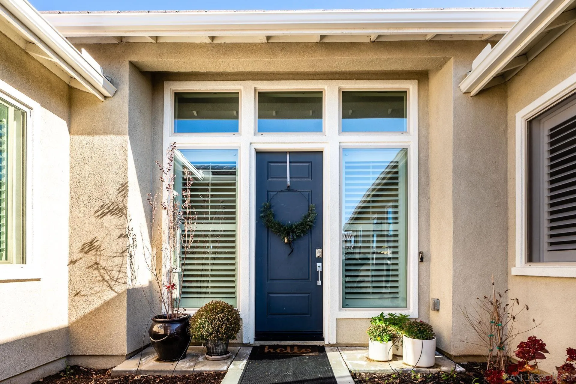 1712 Starlight Avenue Beaumont, CA 92223 - Photo 4 of 69 a window and a potted plant in front of a door