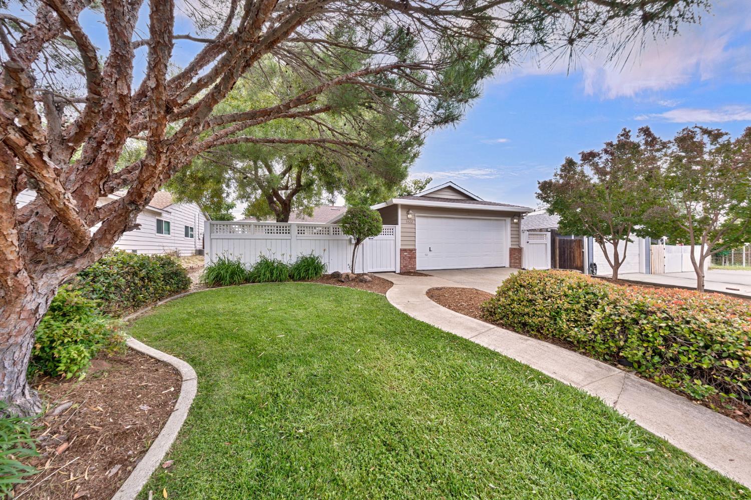 5422 Earnell Street Carmichael, CA 95608 - Photo 3 of 39 a front view of a house with a yard and a large tree