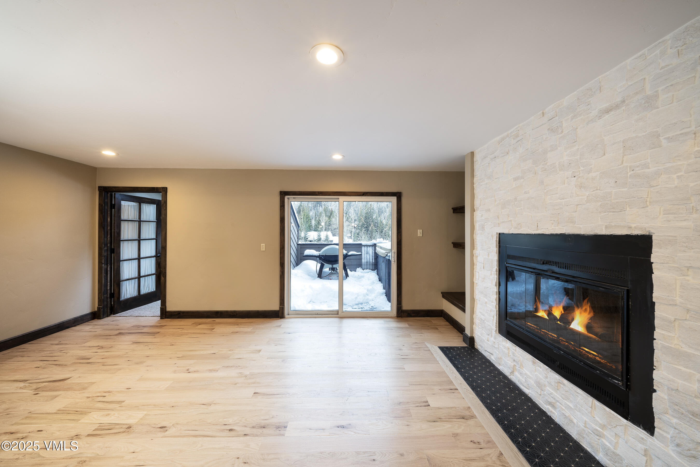 4595 Big Horn Road, Unit 5 Vail, CO 81657 - Photo 12 of 52 a view of an empty room with a fireplace and window