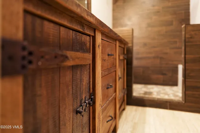 a kitchen with granite countertop a sink a stove a counter space and cabinets