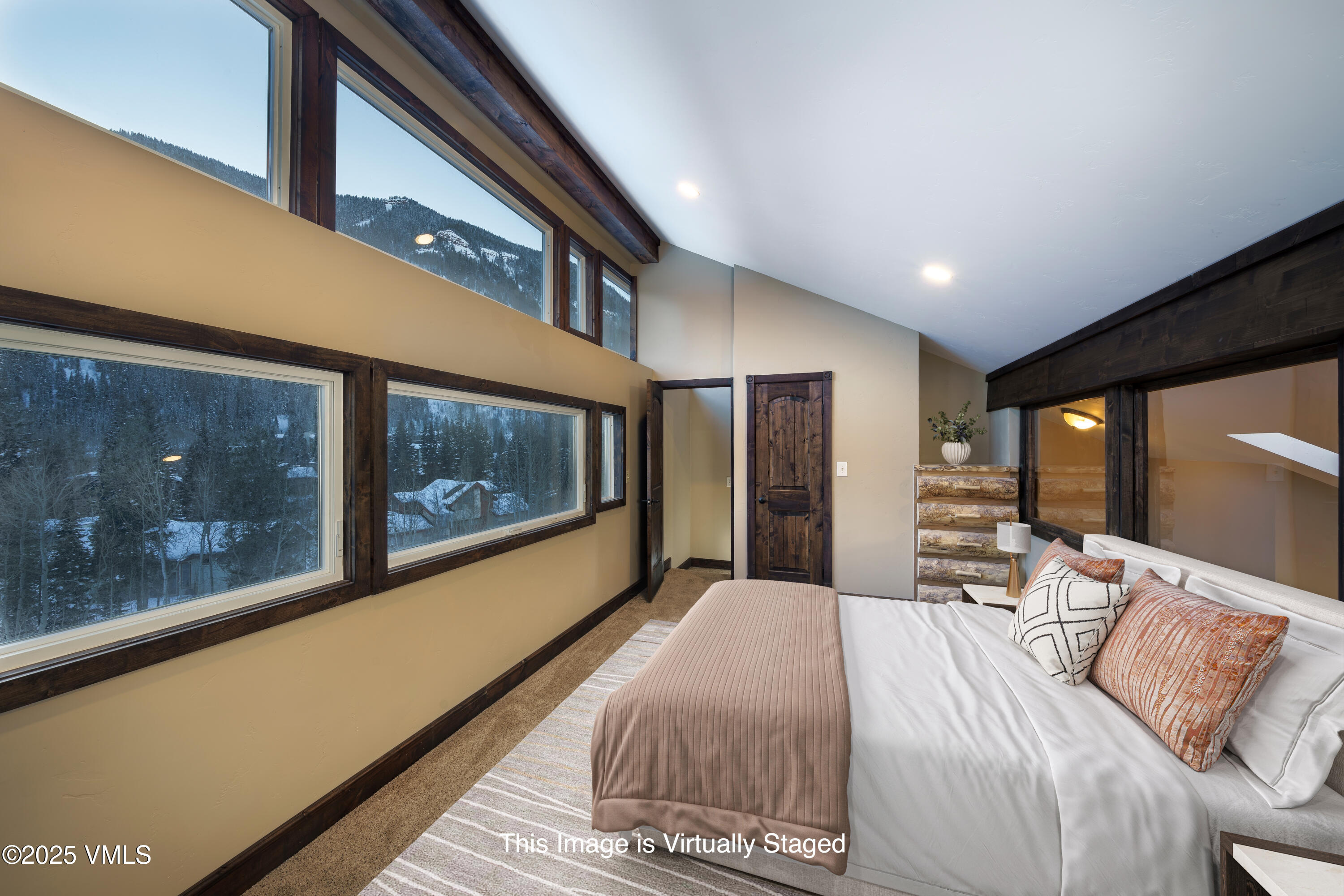 4595 Big Horn Road, Unit 5 Vail, CO 81657 - Photo 26 of 52 a bedroom with a large bed and a large window