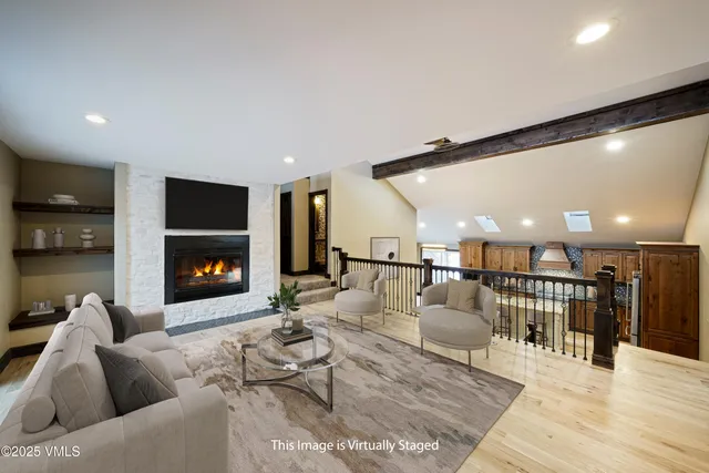 a living room with lots of furniture and a wooden floor