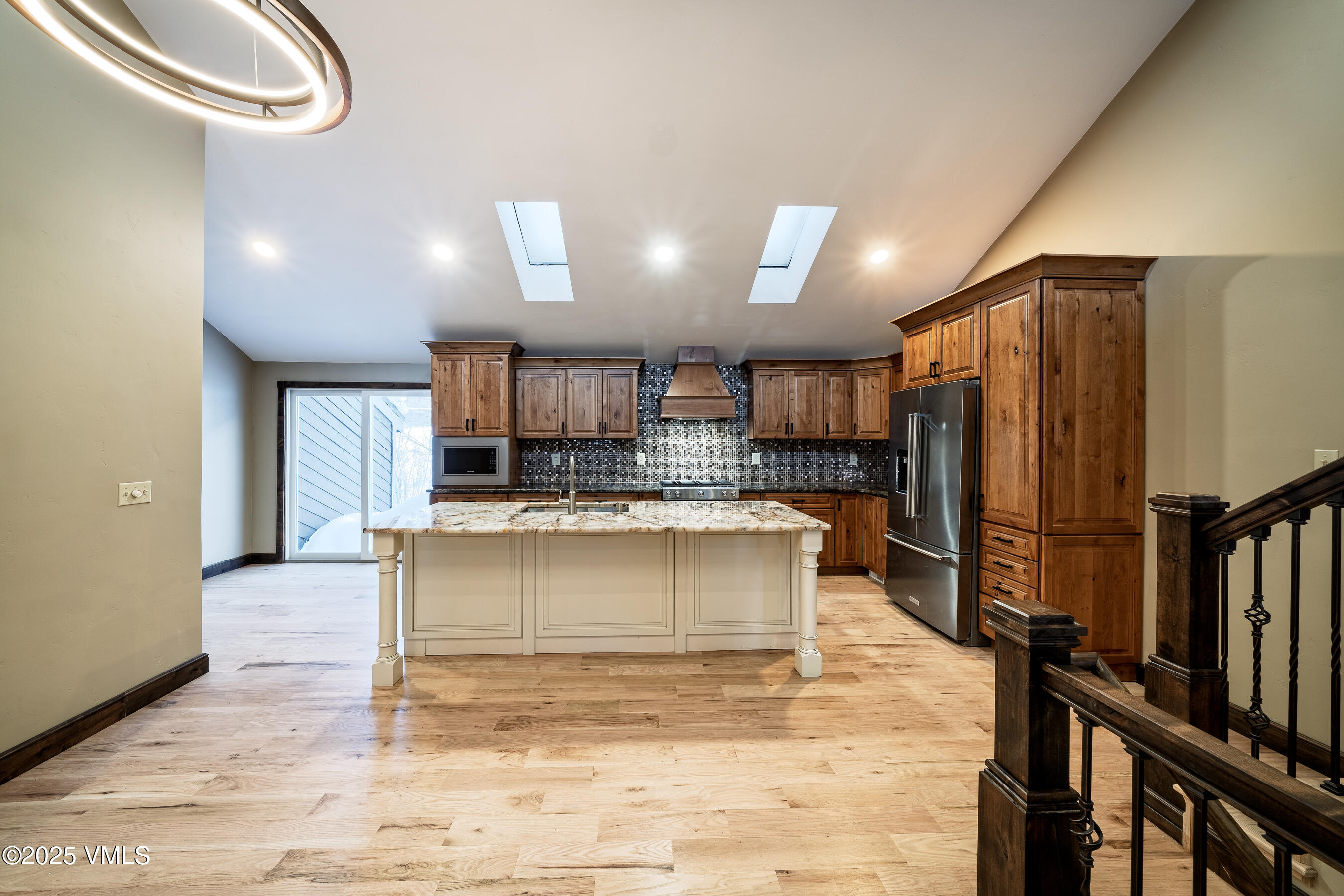4595 Big Horn Road, Unit 5 Vail, CO 81657 - Photo 9 of 52 a view of kitchen with kitchen island stainless steel appliances refrigerator stove microwave and cabinets