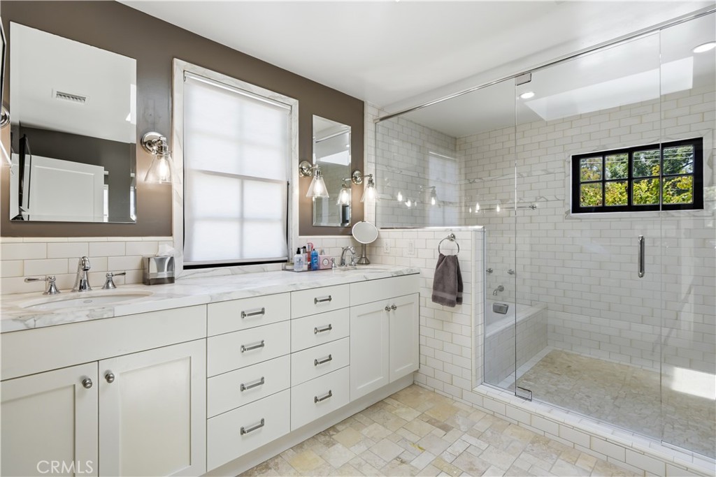 5460 Round Meadow Road Hidden Hills, CA 91302 - Photo 13 of 29 a bathroom with a double vanity sink mirror and shower