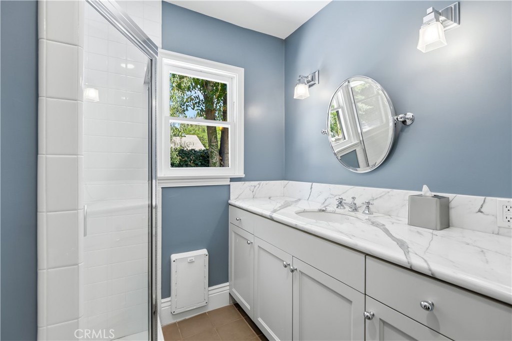 5460 Round Meadow Road Hidden Hills, CA 91302 - Photo 15 of 29 a en suite bathroom with a granite countertop sink and a mirror