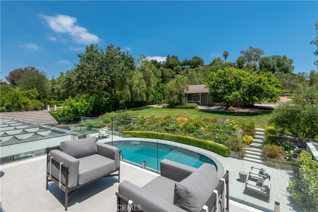 5460 Round Meadow Road Hidden Hills, CA 91302 - Photo 20 of 29 a view of a chairs and table in the patio