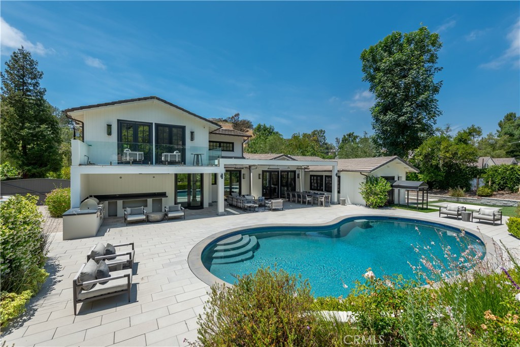 5460 Round Meadow Road Hidden Hills, CA 91302 - Photo 23 of 29 a view of a house with swimming pool and sitting area
