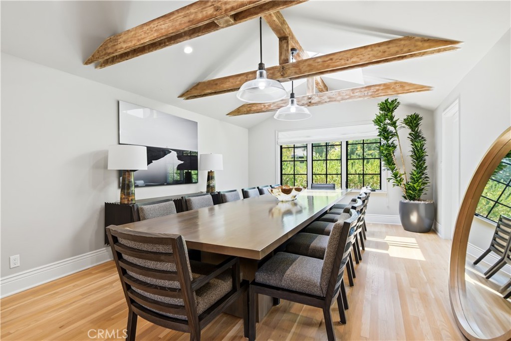 5460 Round Meadow Road Hidden Hills, CA 91302 - Photo 9 of 29 a view of a dining room with furniture wooden floor and a chandelier