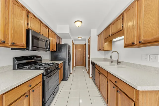 a kitchen with stainless steel appliances a sink stove and cabinets