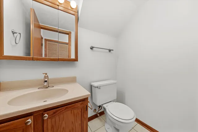 a bathroom with a sink a toilet and mirror