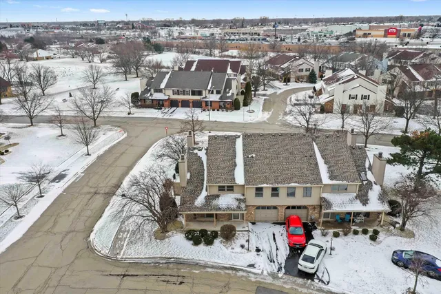 an aerial view of residential houses with outdoor space
