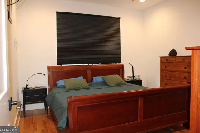 a bedroom with a bed and a dresser