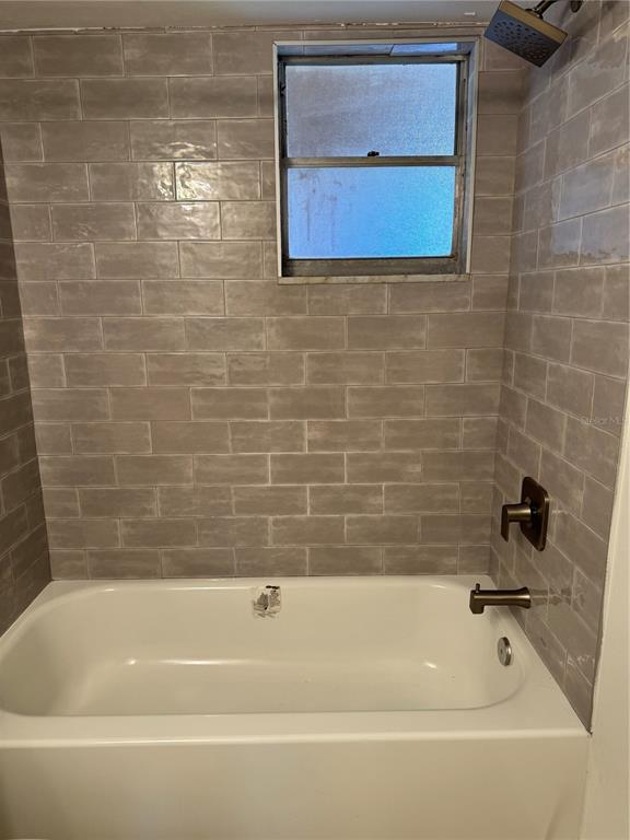 5154 Turquoise Lane, Unit 102 New Port Richey, FL 34652 - Photo 9 of 11 a bathroom with a bathtub
