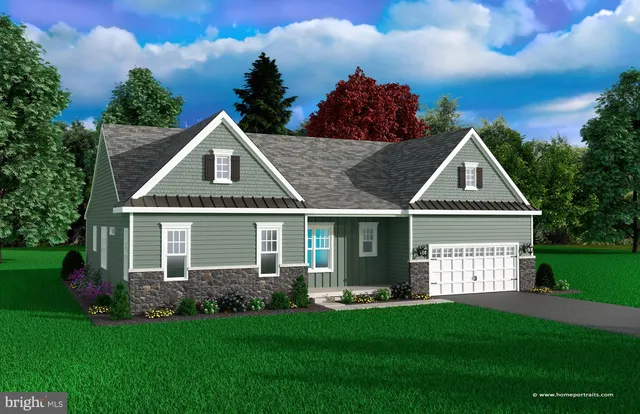 a front view of a house with a yard and trees