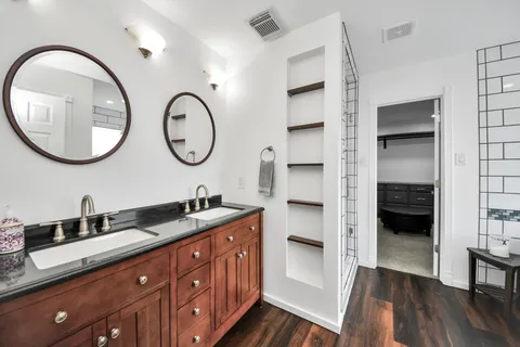 a bathroom with a double vanity sink and a mirror