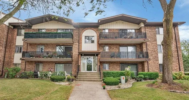 a front view of a residential houses with yard