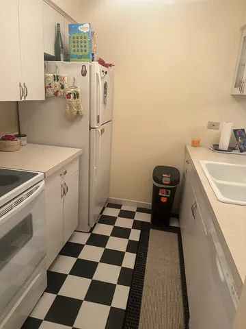 a kitchen with a refrigerator and a sink