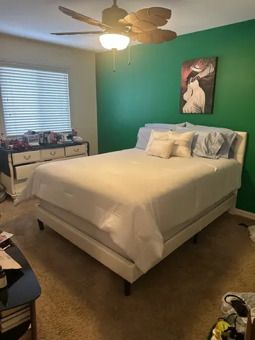 a bedroom with a bed and window