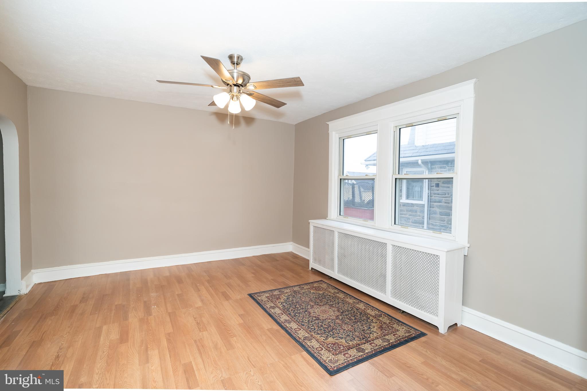 7209 Hazel Avenue Upper Darby, PA 19082 - Photo 12 of 35 an empty room with wooden floor closet and windows