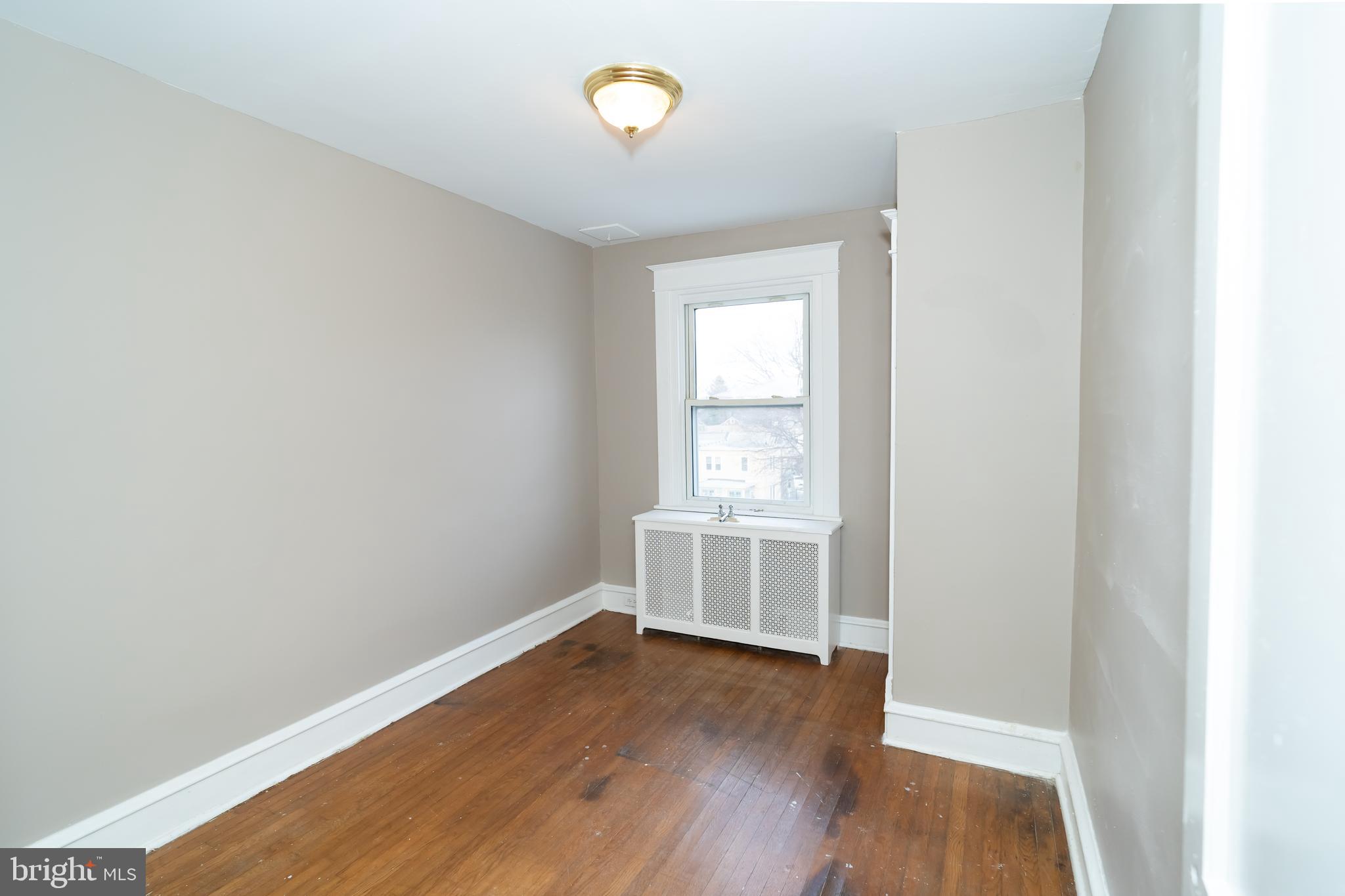 7209 Hazel Avenue Upper Darby, PA 19082 - Photo 20 of 35 an empty room with wooden floor and windows