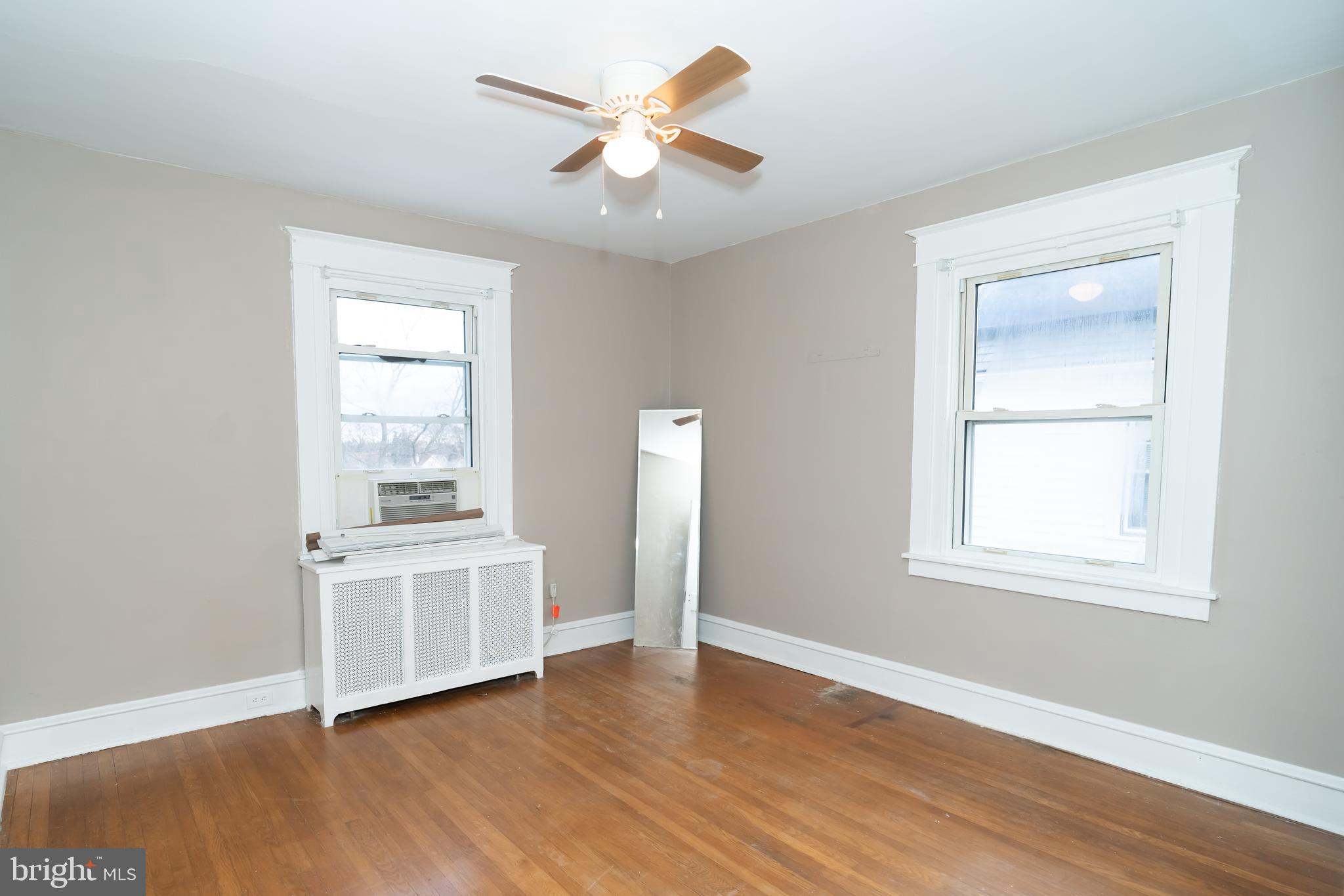 7209 Hazel Avenue Upper Darby, PA 19082 - Photo 24 of 35 a view of an empty room with a window and wooden floor