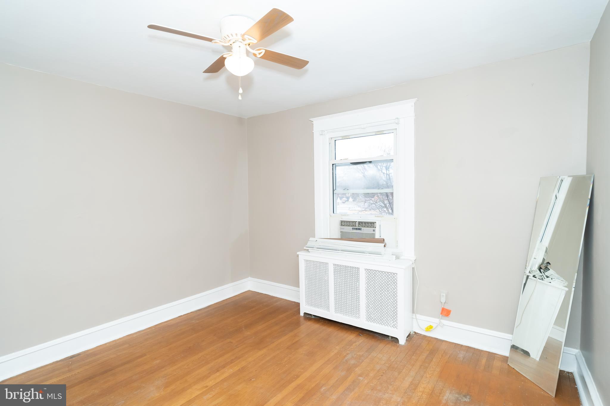 7209 Hazel Avenue Upper Darby, PA 19082 - Photo 25 of 35 an empty room with wooden floor and windows