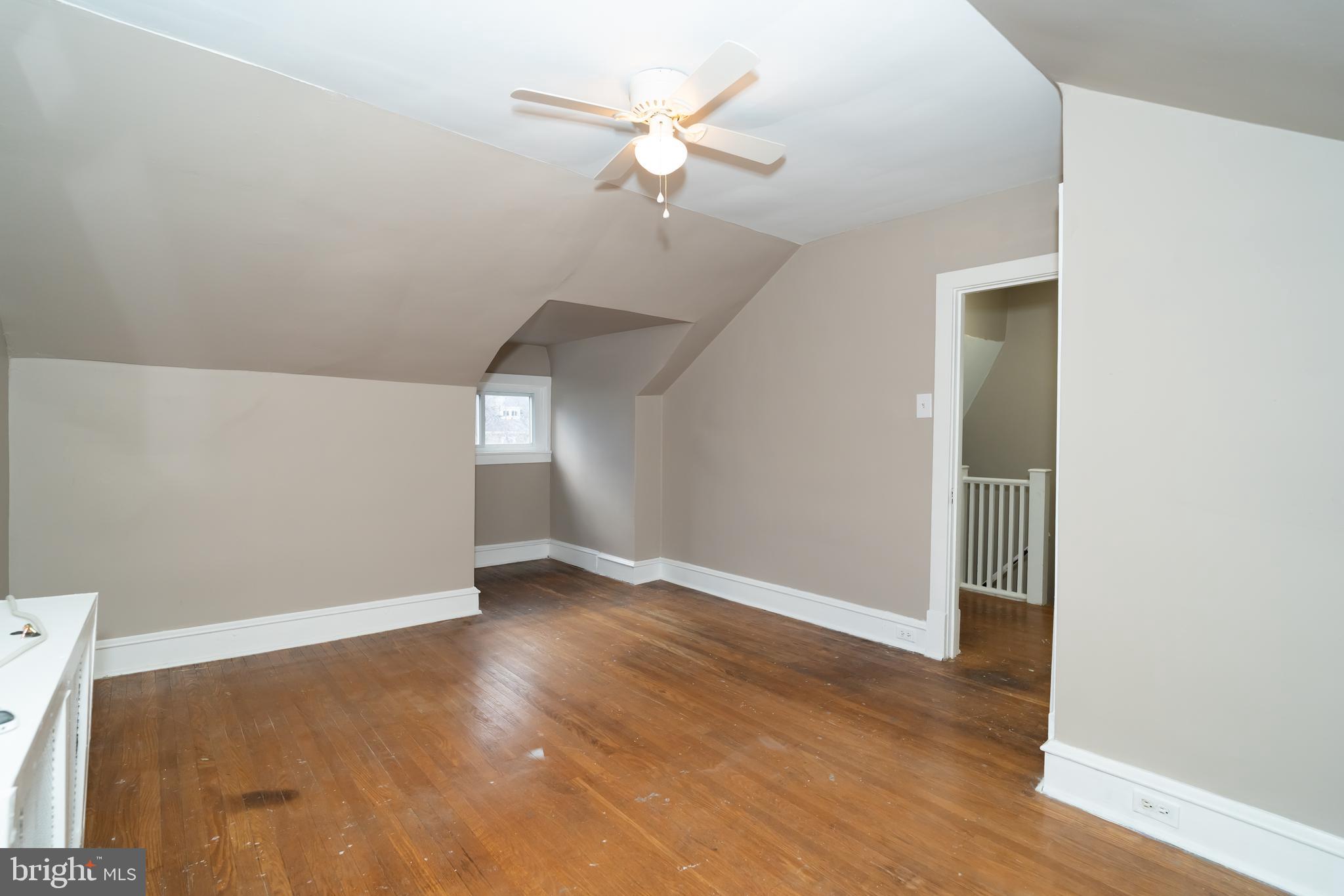 7209 Hazel Avenue Upper Darby, PA 19082 - Photo 29 of 35 an empty room with wooden floor fan and windows