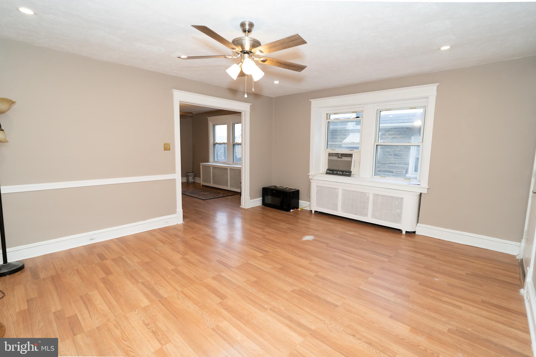 7209 Hazel Avenue Upper Darby, PA 19082 - Photo 10 of 35 wooden floor in an empty room with a window