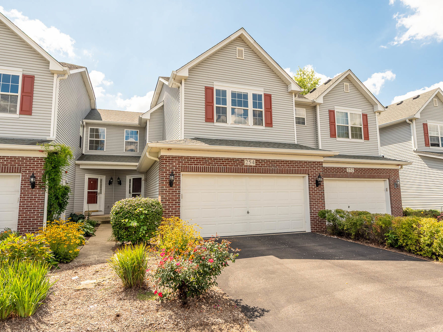 254 Ridge Road North Aurora, IL 60542 - Photo 1 of 14 a view of a white house with a yard and plants