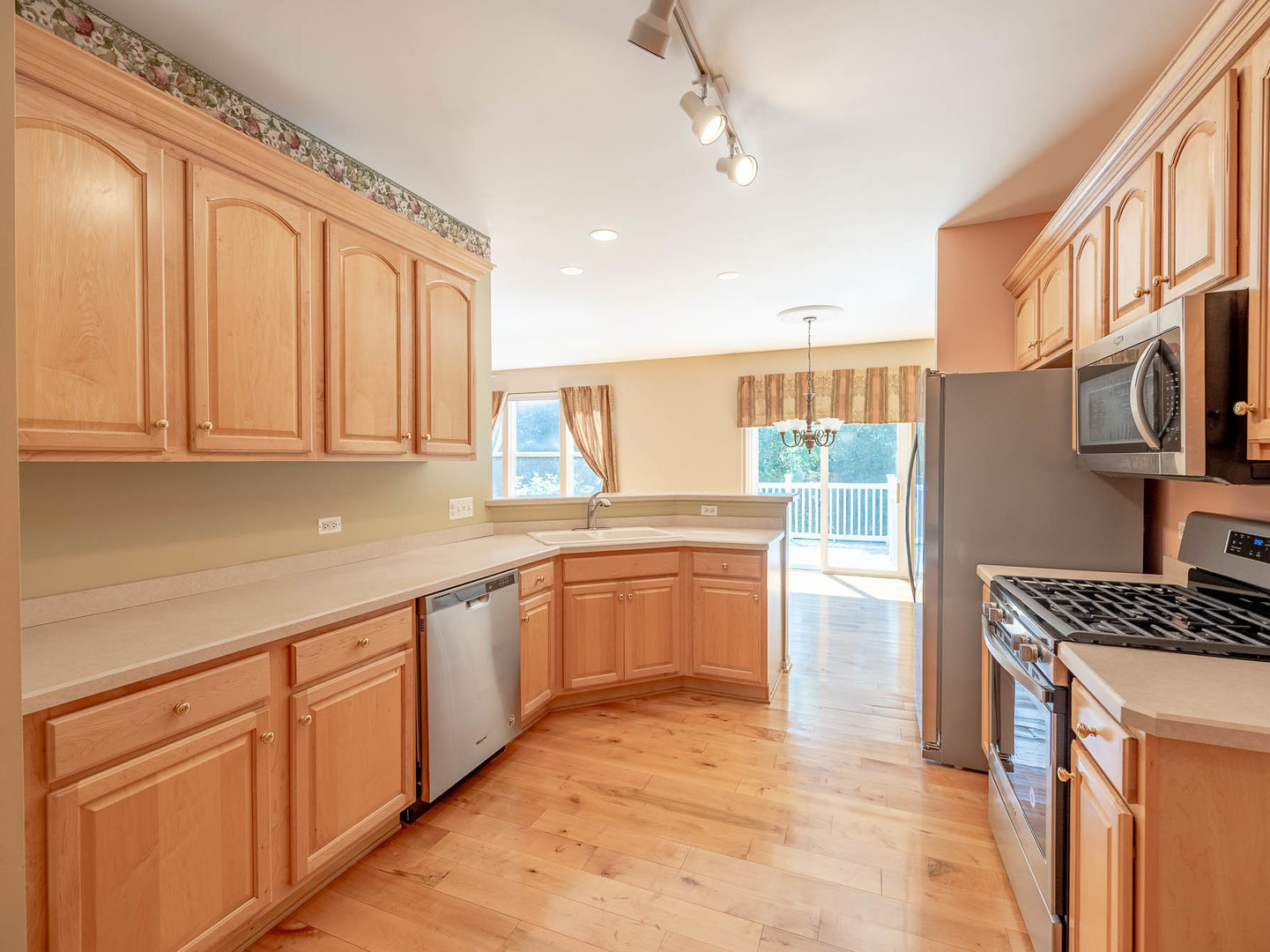 254 Ridge Road North Aurora, IL 60542 - Photo 4 of 14 a kitchen with stainless steel appliances granite countertop a stove a sink and a refrigerator