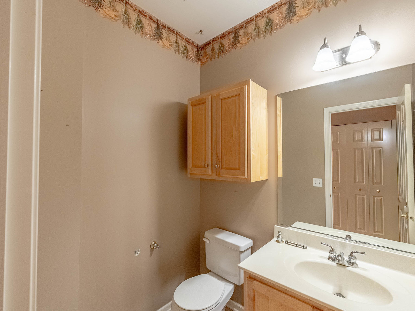 254 Ridge Road North Aurora, IL 60542 - Photo 7 of 14 a bathroom with a sink toilet and mirror