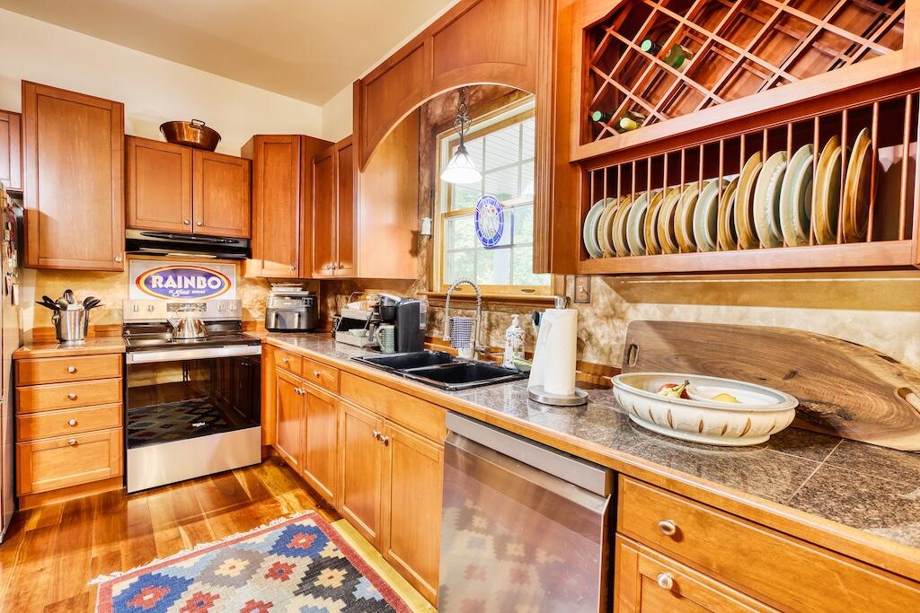 1705 Barberry Road Southeast Floyd, VA 24091 - Photo 11 of 66 a kitchen with stainless steel appliances granite countertop a sink a stove and a wooden cabinets