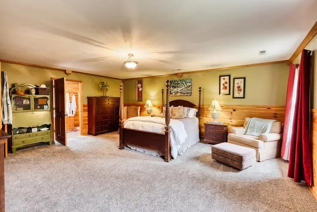 a bedroom with furniture and a large window