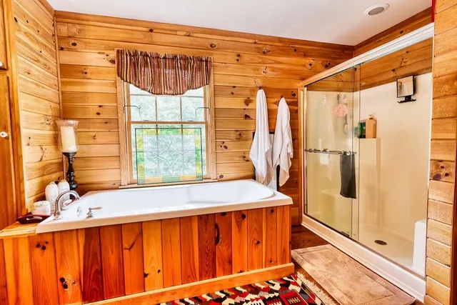 a bathroom with a bathtub and a shower
