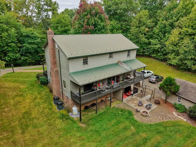an aerial view of a house having patio with a yard
