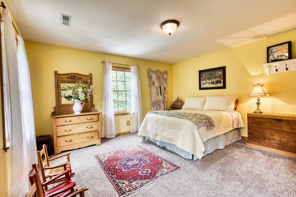 1705 Barberry Road Southeast Floyd, VA 24091 - Photo 21 of 66 a bedroom with a bed and wooden floor